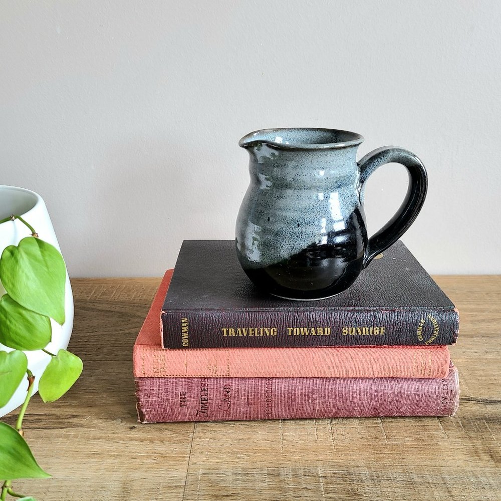Hand made ceramic blue and black pitcher/creamer.